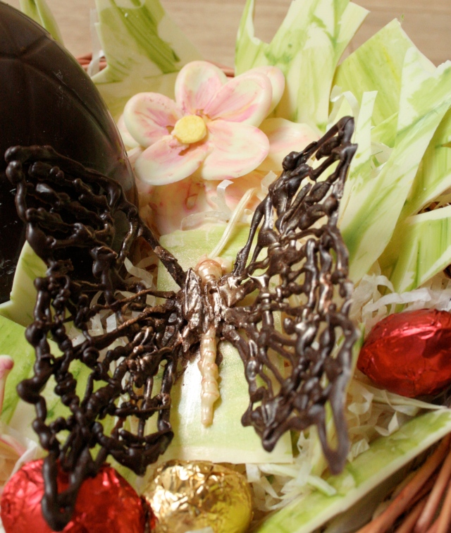 Chocolate butterfly on white chocolate flower